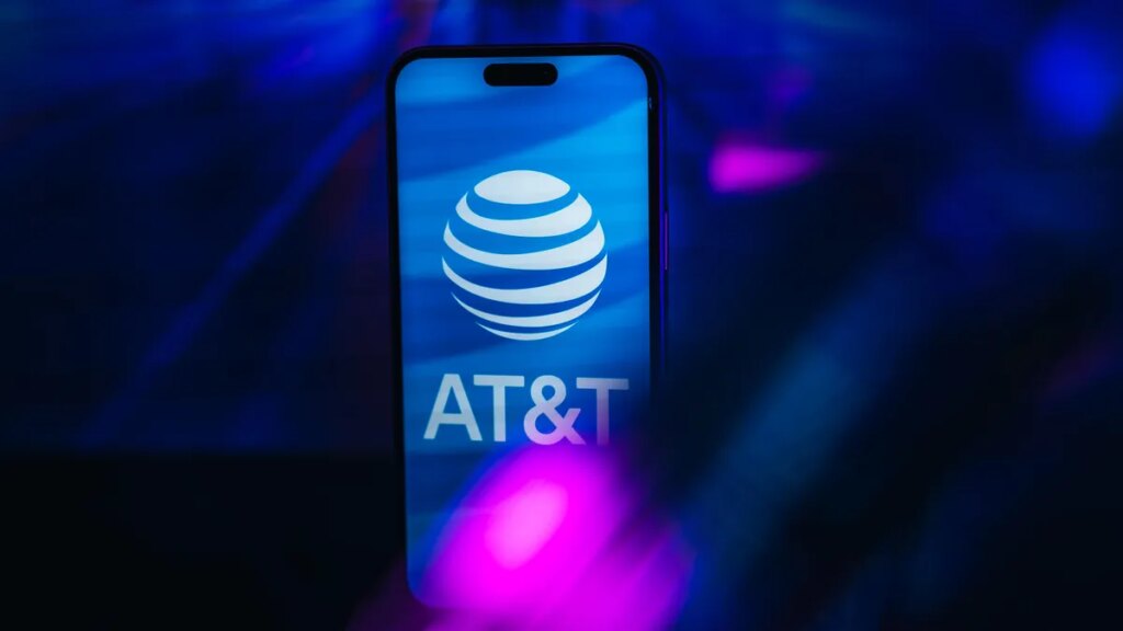 AT&T logo on iPhone screen against a blue backdrop