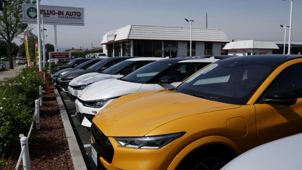 WEST COVINA, CALIFORNIA - MARCH 30: Used electric vehicles are displayed on the sales lot at Plug-In Auto on March 30, 2026, in West Covina, California. As gas prices surge amid the war in Iran, online automotive resource Edmunds reported a 22% increase in searches for electric vehicles during the week of March 2, as motorists look for ways to avoid high fuel costs. (Photo by Justin Sullivan/Getty Images)