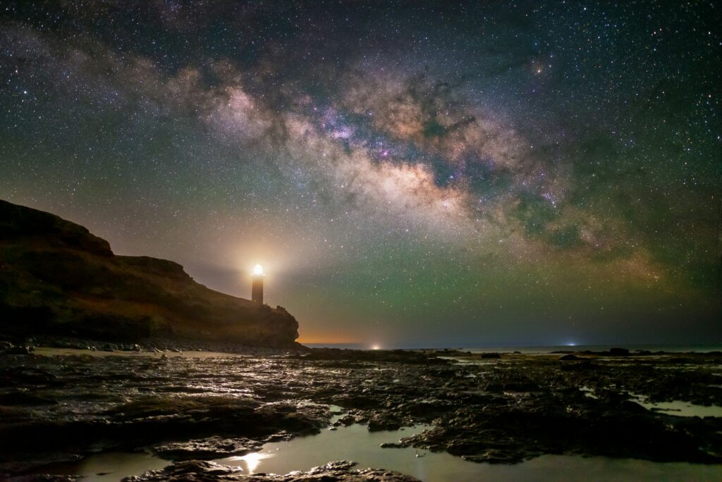 a light house by night under the stars