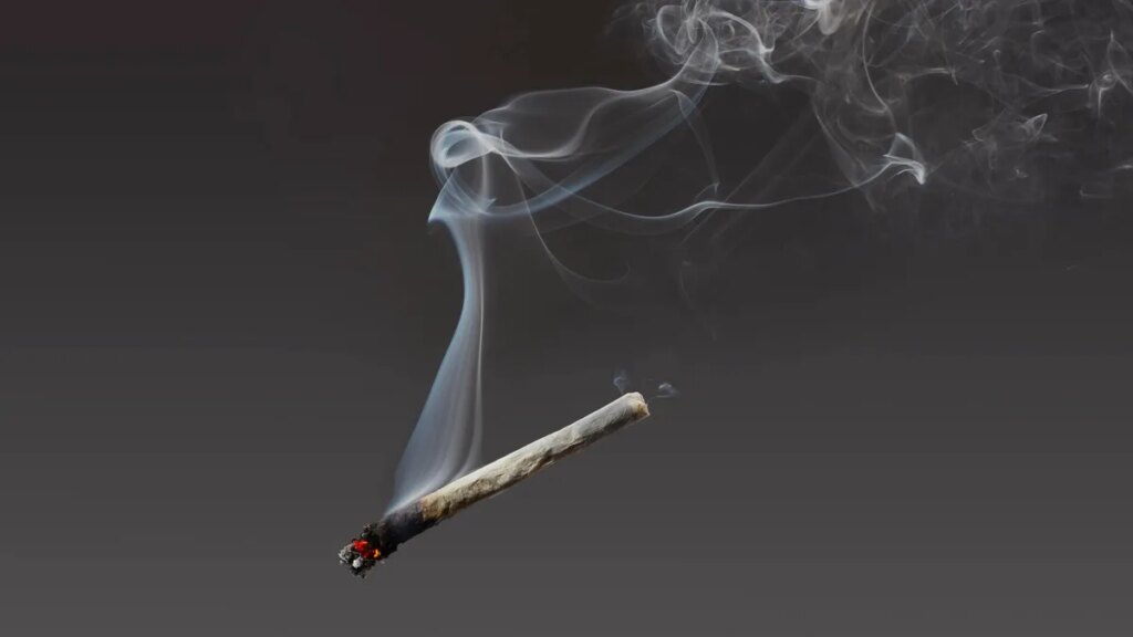 marijuana cigarette suspended in air with smoke wafting