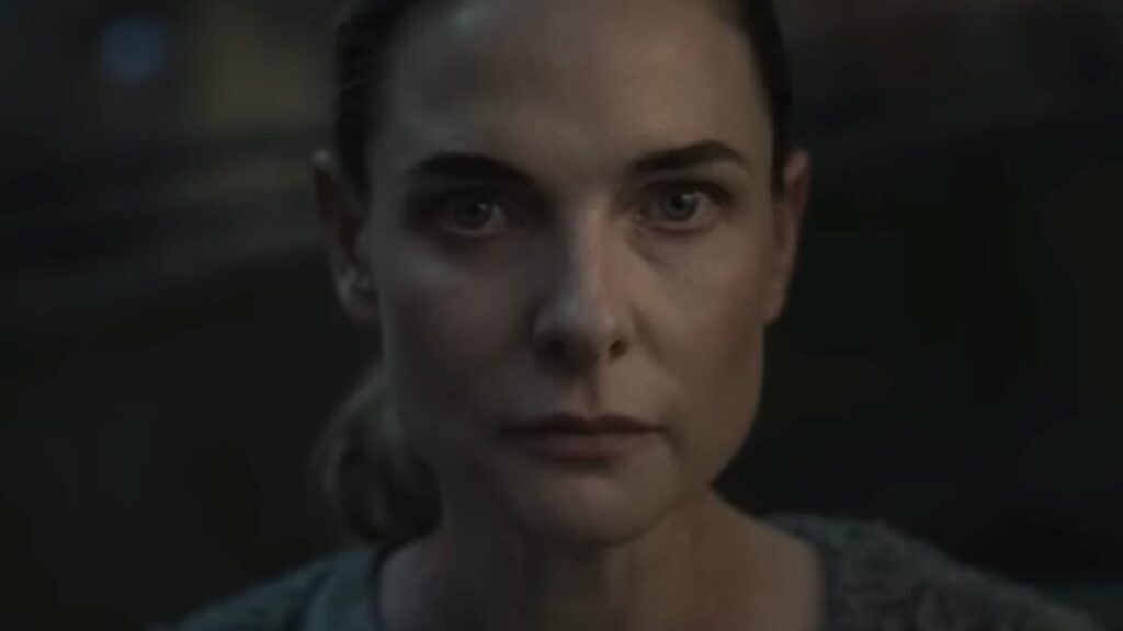 close up of woman with hair pulled back in a ponytail looking resolved