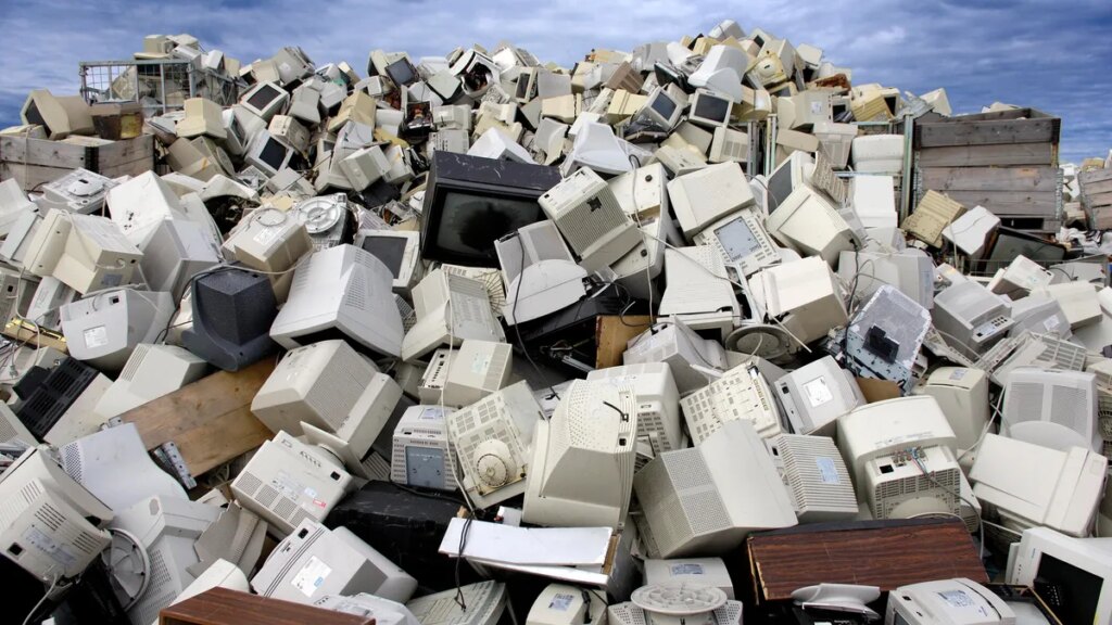 A pile of computers and monitors